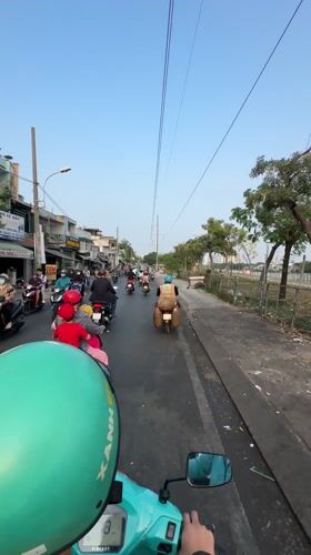 Motorcyclists navigate midnight traffic in Ho Chi Minh City
