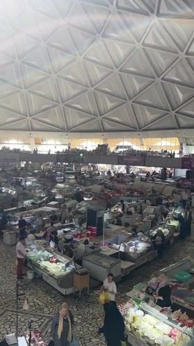 Market activity documented under geometric dome in Tashkent