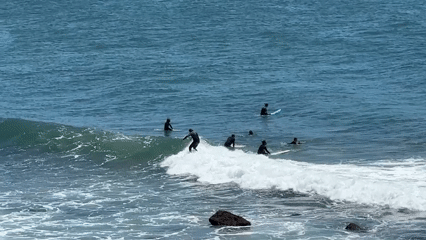 Surfer wipes out on waves near Cascais, Portugal beaches