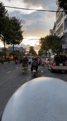 Motorcyclist in floral shirt travels road in Đồng Nai