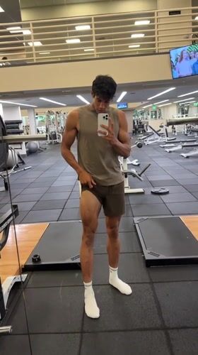 Young man records workout selfie in Los Angeles gym