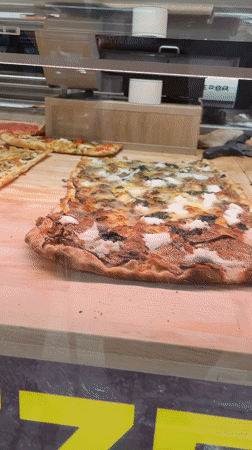 Pizza al taglio displayed at Roman establishment