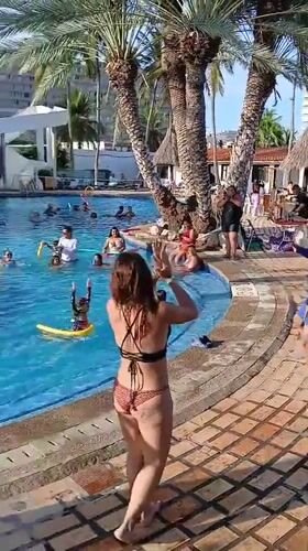 Resort pool party with live entertainment captured in Porlamar
