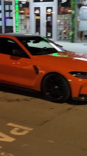 Orange BMW spotted parked on Nesebar street during evening