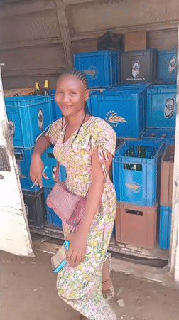 Woman at beer delivery truck, seed pods examined in Jos