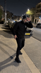 Man performs martial arts on Jerusalem street at night