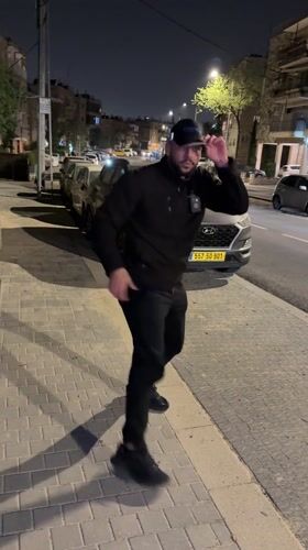 Man performs martial arts on Jerusalem street at night