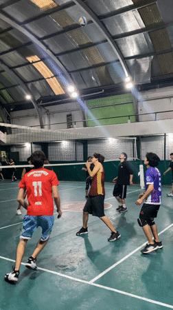 Evening volleyball game observed in Wilde, Argentina gymnasium