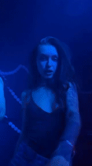 Woman dances, sings in colored lights at Moscow venue