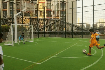 Children play soccer on Mumbai turf field