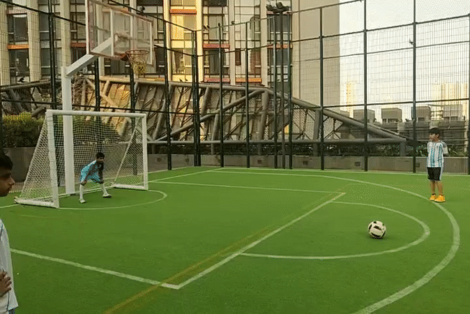 Children play soccer on Mumbai turf field