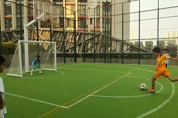 Children play soccer on Mumbai turf field