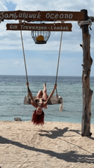 Woman enjoys beach swing at Gili Trawangan resort