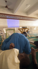 Men use laptops in Nigerian mosque during afternoon gathering