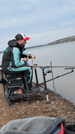 Morning angler catches fish along Kama River in Chaikovsky