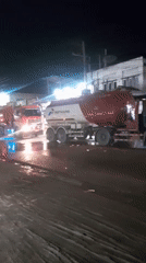 Pertamina fuel trucks lined up on wet Indonesian street