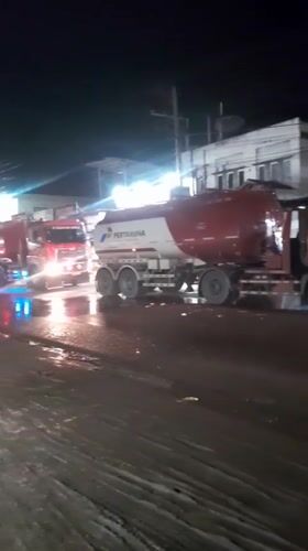 Pertamina fuel trucks lined up on wet Indonesian street