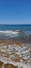 Clear-water coastline explored on a bright sunny day