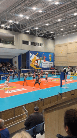 Boy stands among blooming trees in Burgas, Bulgaria