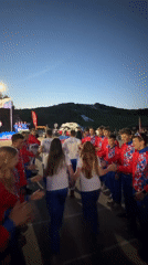 Ceremonial high-five formation and flag display in Khvalynsk