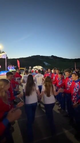 Ceremonial high-five formation and flag display in Khvalynsk