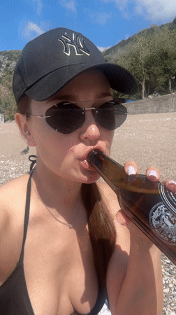 Woman films beach selfie videos at Montenegro's Kamenovo bay