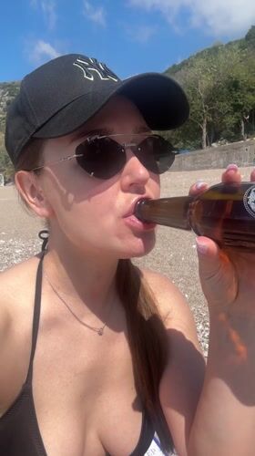 Woman films beach selfie videos at Montenegro's Kamenovo bay
