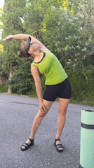 Woman performs morning outdoor exercise routine with yoga mat