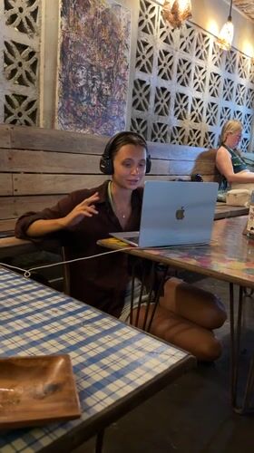 Woman conducts video call at General Luna cafe