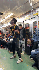 Man in face paint dances on Buenos Aires subway