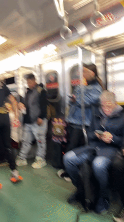 Man in face paint dances on Buenos Aires subway