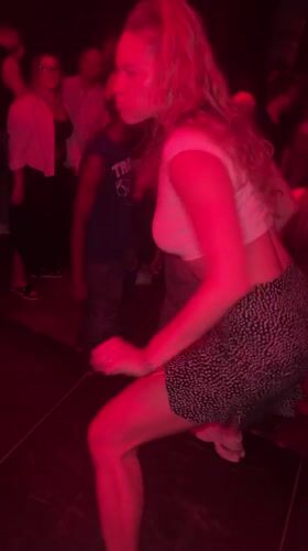 Dancing under red lights at a Warsaw nightlife spot