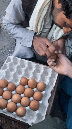 Egg vendors conduct business at outdoor market in Yaro