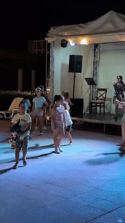 Night poolside event with dancing and lights in Constanța