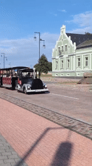Tourist train and bronze bench statue in Ventspils