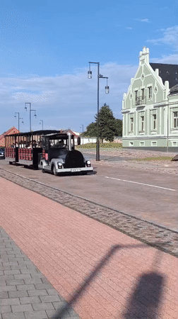 Tourist train and bronze bench statue in Ventspils