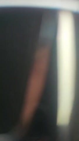 The video shows a person driving a car. The camera is focused on the dashboard, which displays the speedometer and other indicators. The car appears to be moving at a moderate speed, with the needle on the speedometer indicating around 80 km/h. The video also captures the view through the windshield, which shows a road with trees and other vehicles in the distance. The weather appears to be overcast or rainy. The car has a Honda emblem on the steering wheel.