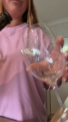 Cape Town resident opens sparkling wine during Friday morning rainstorm