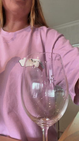 Cape Town resident opens sparkling wine during Friday morning rainstorm