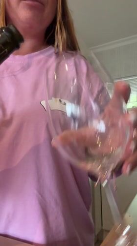 Cape Town resident opens sparkling wine during Friday morning rainstorm
