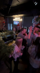 Young adults dance and sing at Saint Petersburg bar