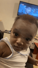 Baby filmed looking at camera in Nigerian village