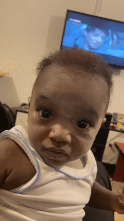 Baby filmed looking at camera in Nigerian village
