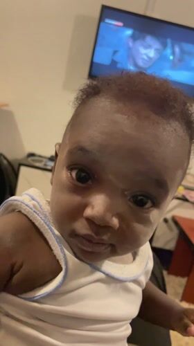 Baby filmed looking at camera in Nigerian village