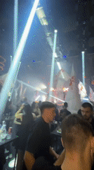 Nightclub crowd waves flags at late-night Plovdiv event