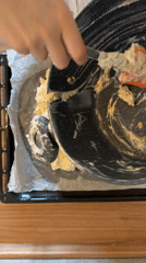 Baker prepares dough on baking sheets in Catania