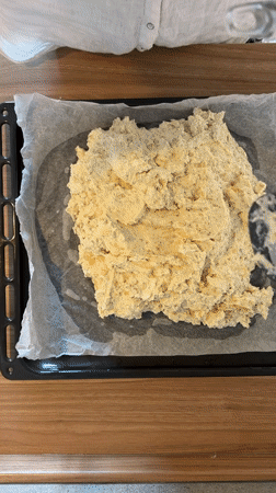 Baker prepares dough on baking sheets in Catania