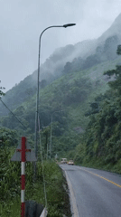 Foggy mountain road and roadside monument in Thôn 5, Vietnam