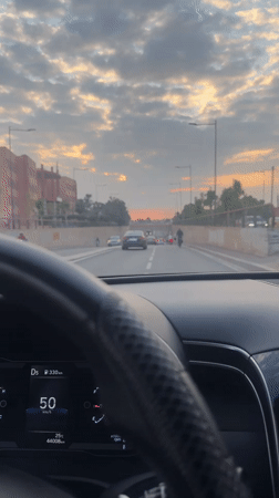 Evening drive captured through palm-lined streets of Marrakesh