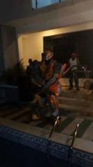 Transformer costume spotted at nighttime pool party in Nigeria